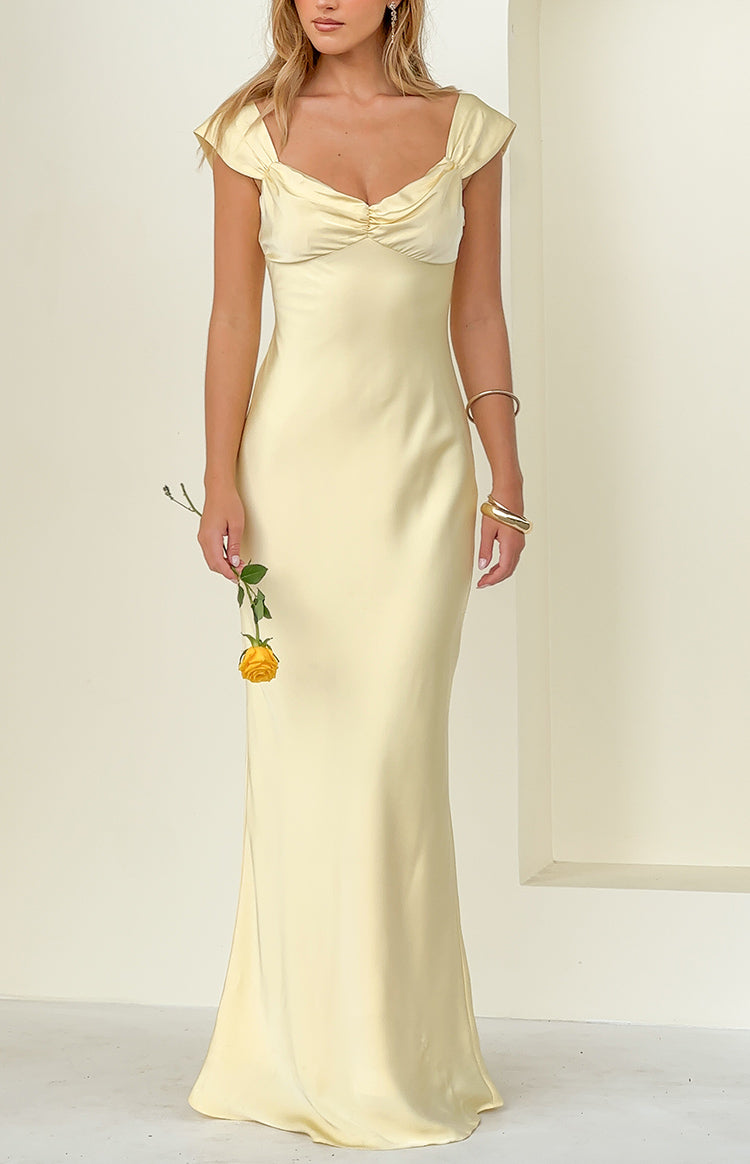Front view of a yellow satin maxi dress featuring a ruched sweetheart neckline and draped off-shoulder cap sleeves