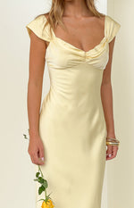 Close-up of the yellow satin maxi dress showing the sweetheart neckline with ruched bust and short cap sleeves