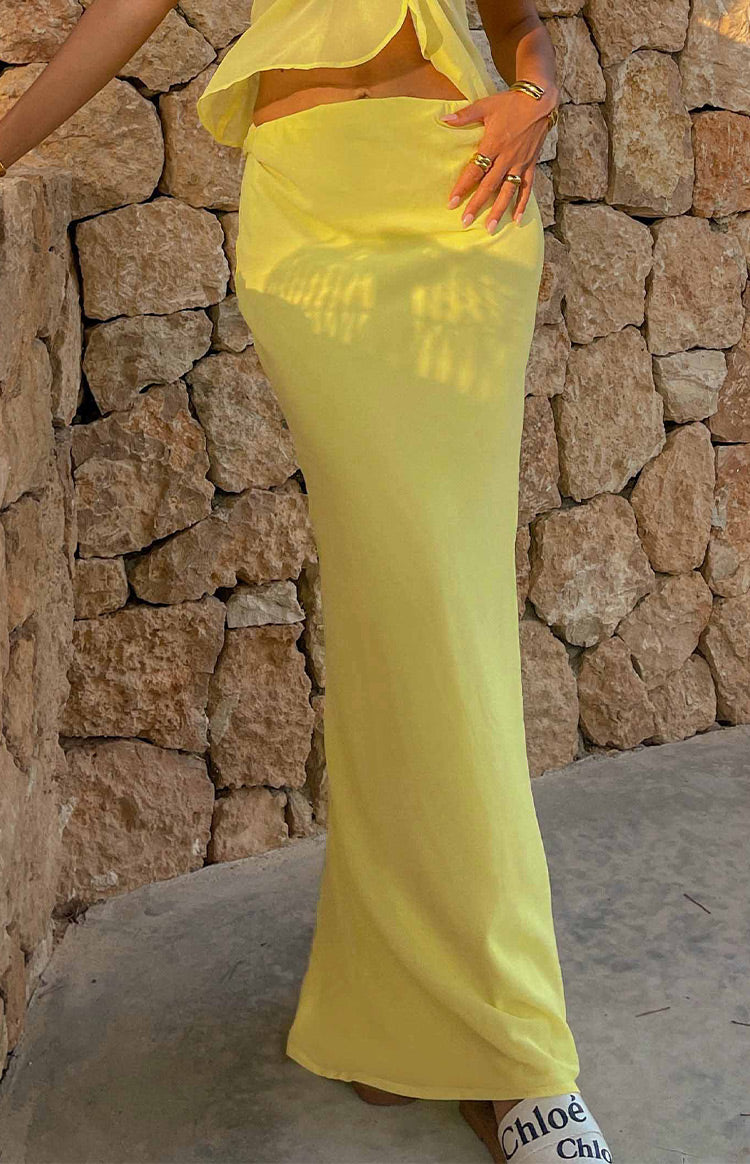 Light yellow fitted maxi skirt showing its full length and flowing drape