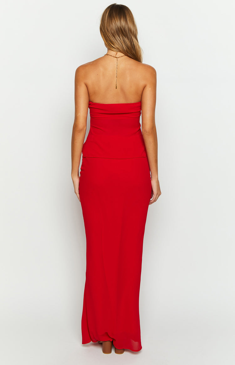 Rear view of a red fitted maxi skirt, showing the smooth fabric and long, flowing drape