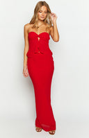 Close-up front view of a red strapless top with a central twisted knot and a layered peplum detail