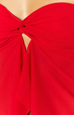 Close-up of the twisted knot detail creating a small cutout at the bust of a red strapless top