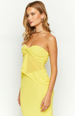 Side view of a yellow strapless top with a twisted bust and sheer mesh panel on the side bodice