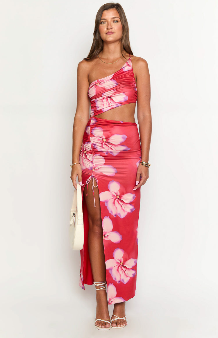 Front view of a red crimson floral maxi dress with one-shoulder neckline, waist cutouts, and a ruched drawstring side slit