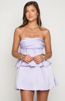 blonde girl wearing a strapless satin babydoll homecoming dress