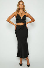 Black satin V-neck crop top with thin spaghetti straps, a ruffled hem, and delicate lace trim