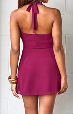 Rear view of a burgundy halter neck mini dress, showing the tie closure at the back of the neck