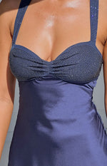 Close-up of the navy mini dress showing rhinestone embellished bust cups with ruched detail and satin skirt