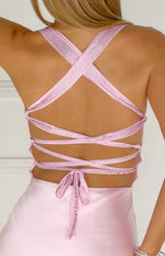 Rear view of a pink satin maxi dress with criss-cross rhinestone straps and multiple horizontal tie-back straps