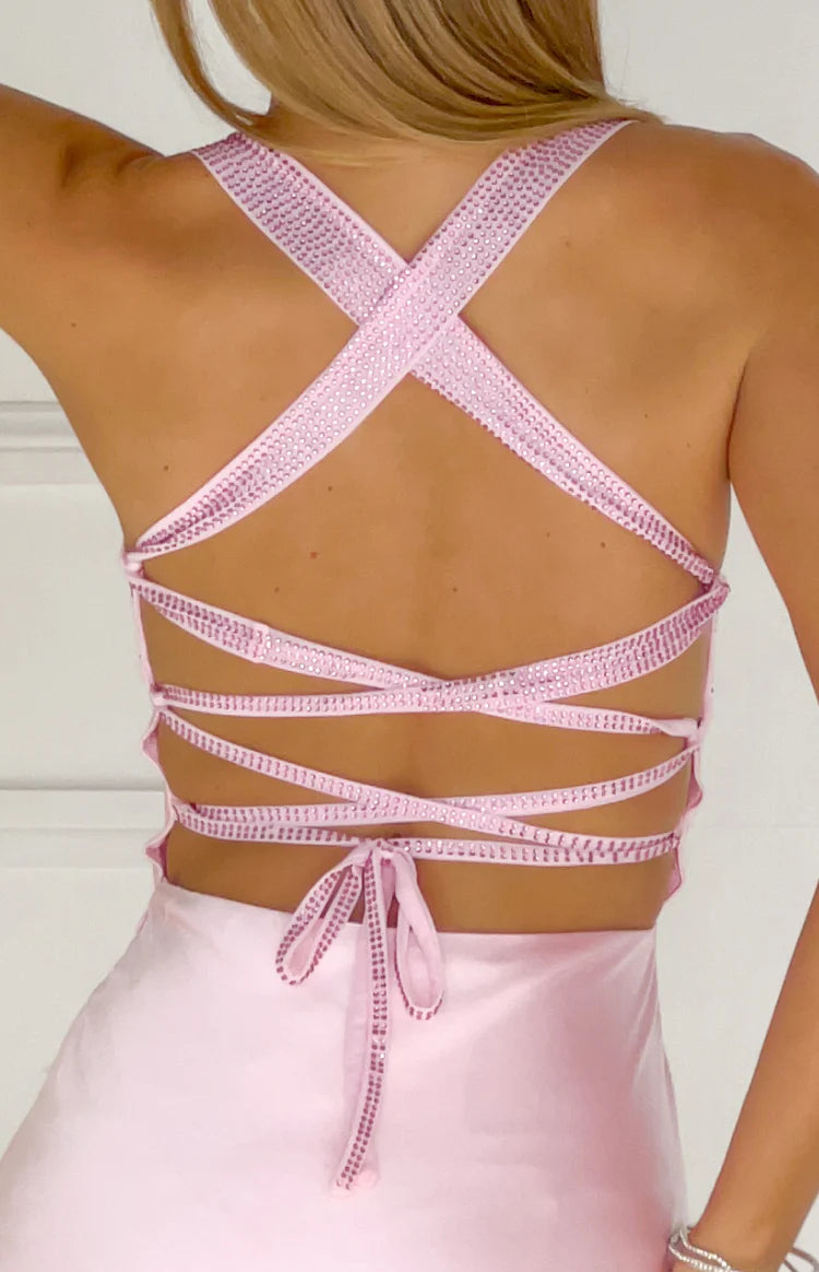 Rear view of a pink satin maxi dress with criss-cross rhinestone straps and multiple horizontal tie-back straps