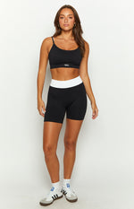 Black ribbed knit ballet crop top with scoop neck and white contrast stitching