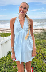 Light blue halter neck mini dress with a deep V-neck and white scalloped trim along the neckline and straps