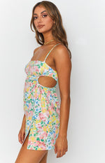 Pastel floral print mini dress with square neckline, ruched side cutouts, and a thigh-high slit