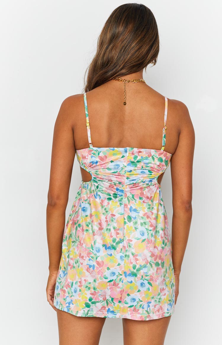 Pastel floral mini dress with ruched back, side cutouts, and adjustable spaghetti straps