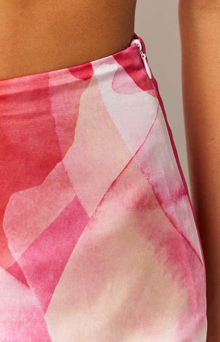 Close-up of the pink abstract print and fitted silhouette of the mini skirt