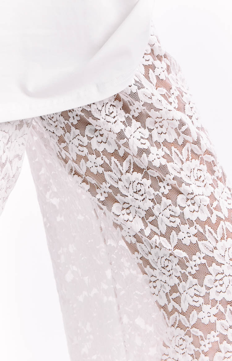 Close-up of the sheer white floral lace fabric of the pants, highlighting the intricate pattern