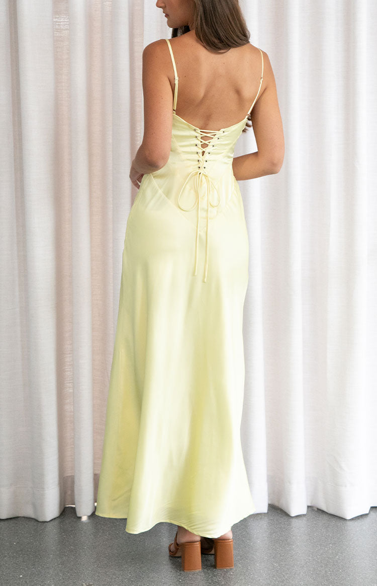 Rear view of a yellow maxi dress with a lace-up corset back and thin spaghetti straps