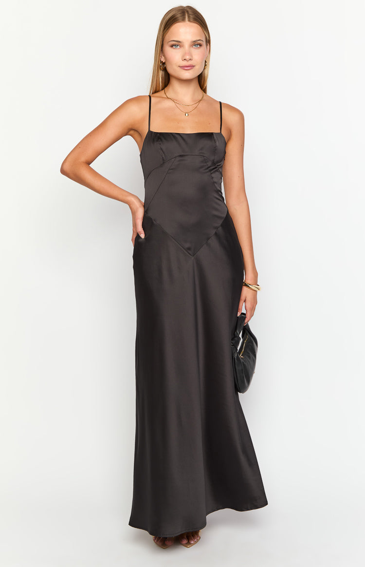 Black satin maxi dress with a square neckline, thin spaghetti straps, and V-shaped seam detail at the waist