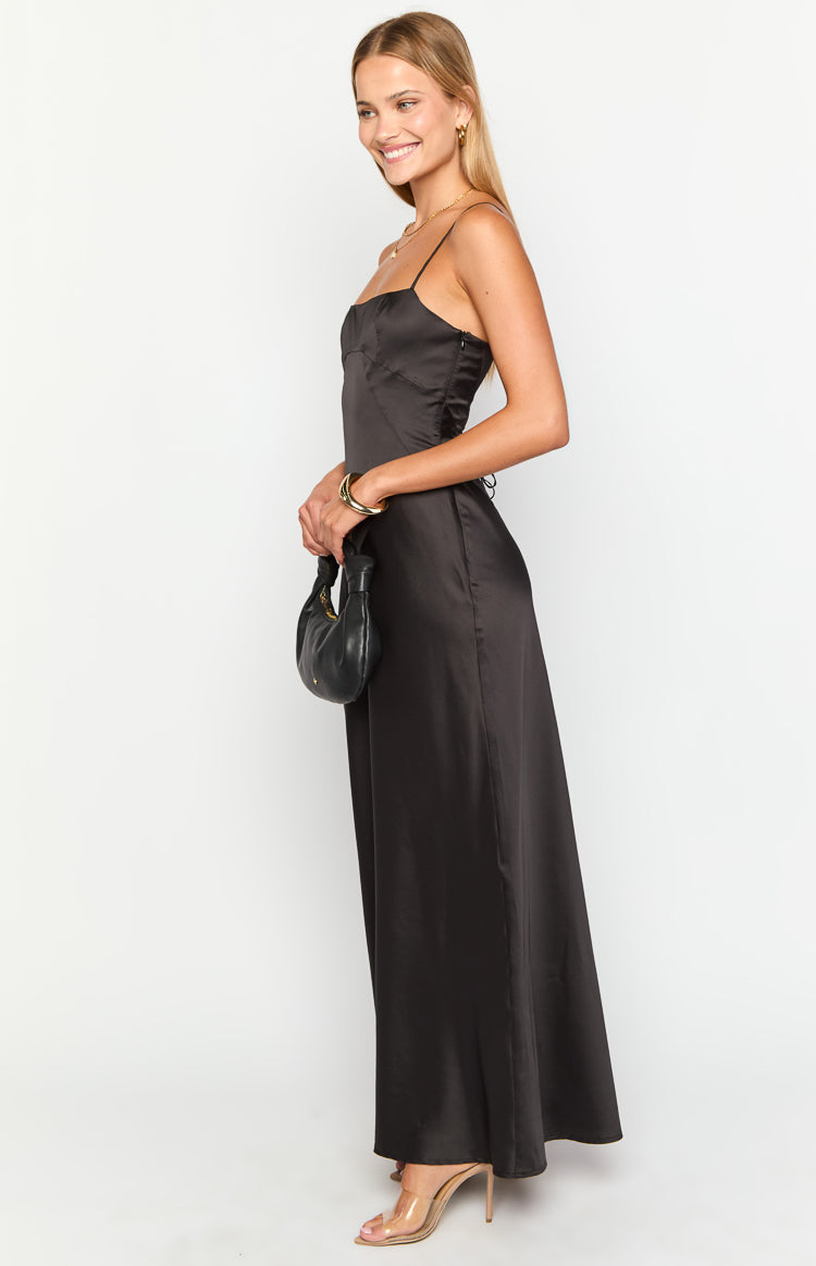 Side view of a black satin maxi dress with a square neckline, thin spaghetti straps, and side lacing detail on the bodice
