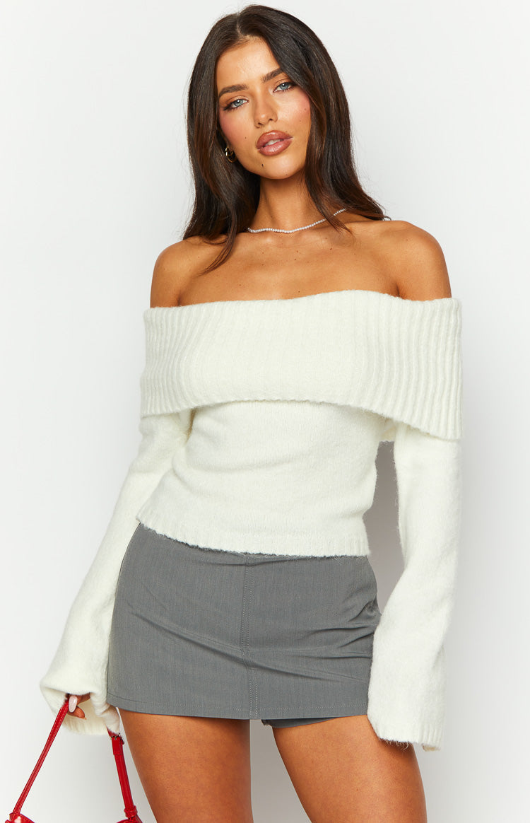 Cream off-shoulder sweater with a wide ribbed fold-over neckline and soft fuzzy knit texture