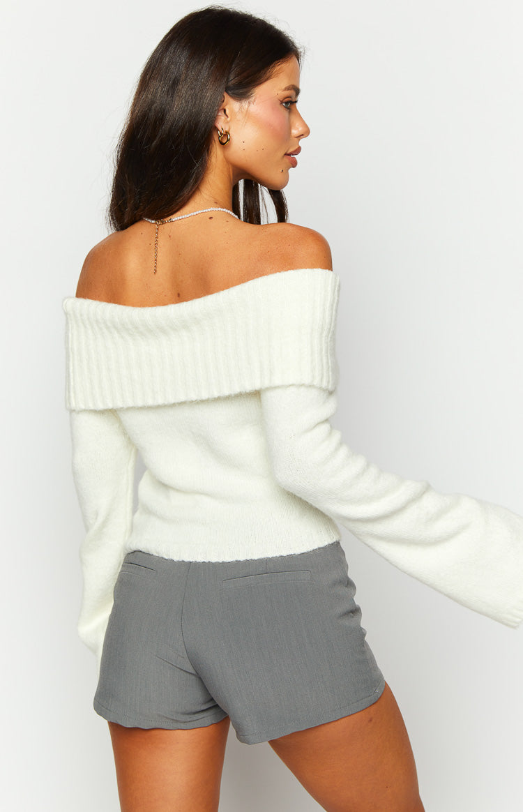 Rear-side view of a cream fluffy knit off-shoulder sweater with a wide folded collar and long sleeves