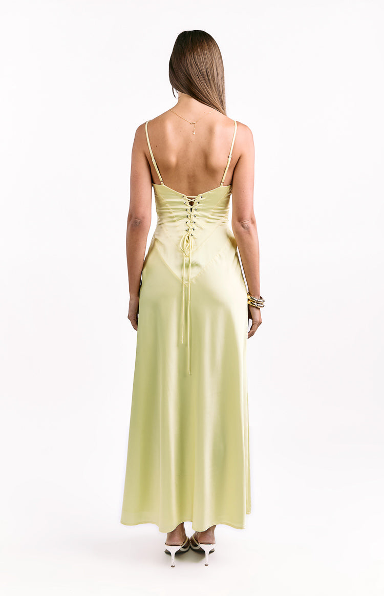Rear view of a pale yellow satin maxi dress with thin spaghetti straps and a lace-up corset back