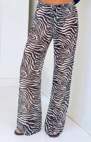 Beginning Boutique Joplin Black Sheer Zebra Print Pants black and white zebra print sheer wide-leg pants with drawstring wais