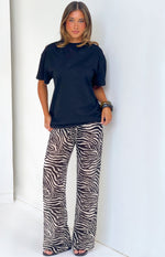 Full length front view of black sheer zebra print wide leg pants with a visible drawstring waist