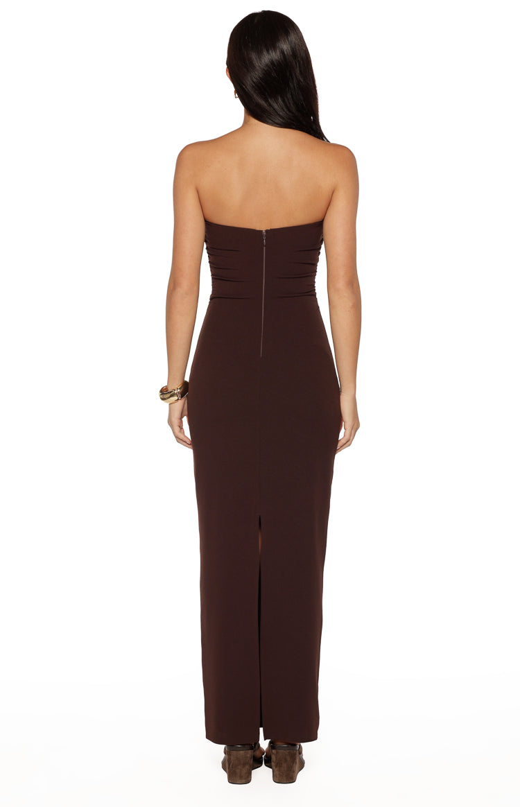 Rear view of a brown crepe strapless maxi dress with a back zipper and a long skirt slit