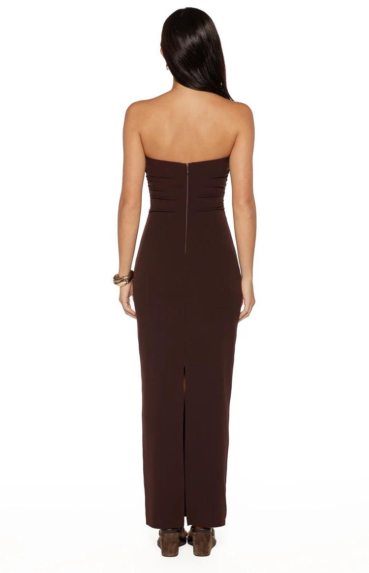 Rear view of a brown crepe strapless maxi dress with a back zipper and a long skirt slit