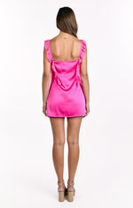Rear view of a hot pink satin mini dress with ruffled shoulder straps and a square back neckline
