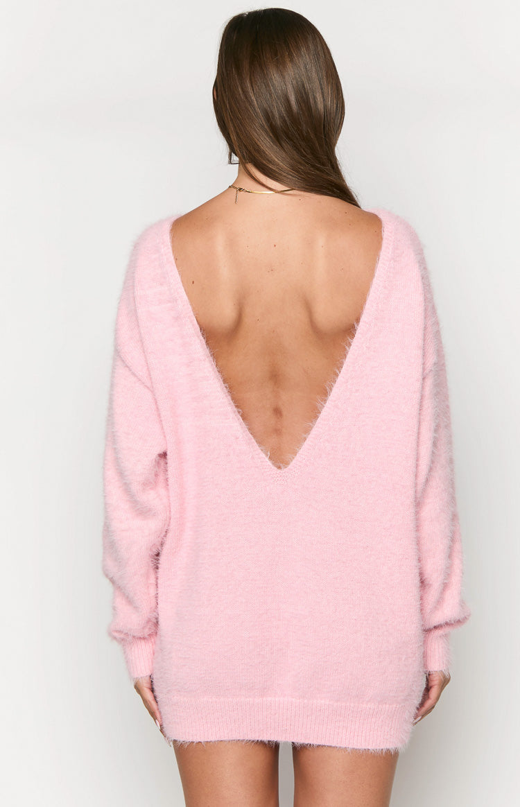 Back view of a pink fluffy knit mini dress featuring a deep V-neckline