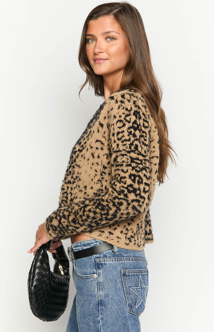 Side view of the tan and black leopard print cardigan, showing its cropped length and fuzzy knit texture