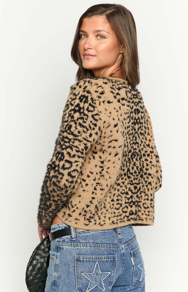 Partial rear view of a tan and black leopard print cardigan with a fuzzy knit texture and cropped hem