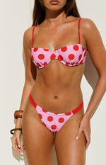 Pink and red polka dot bikini bottoms with high-cut leg and red trim