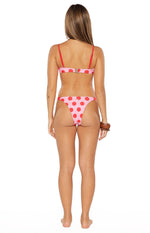 Rear view of pink and red polka dot bikini bottoms with high-cut leg and cheeky coverage