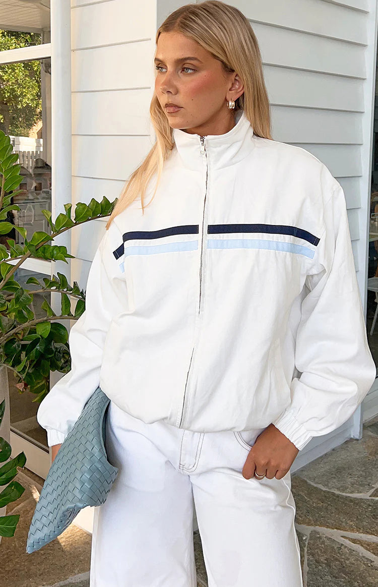 Rear view of a cream funnel neck jacket with a horizontal seam across the upper back and elasticated hem