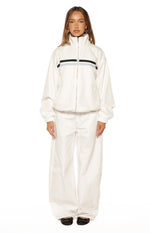 Full front view of a cream funnel neck jacket with black and light blue chest stripes, elasticated cuffs and hem