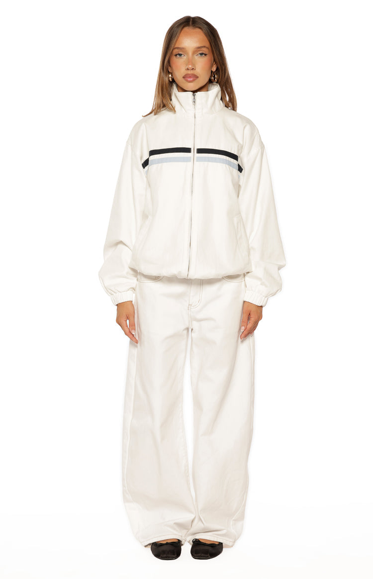 Full front view of a cream funnel neck jacket with black and light blue chest stripes, elasticated cuffs and hem