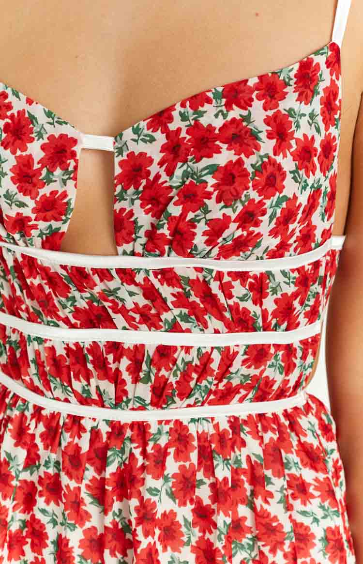 Rear view of the red floral mini dress with white spaghetti straps that tie at the open back