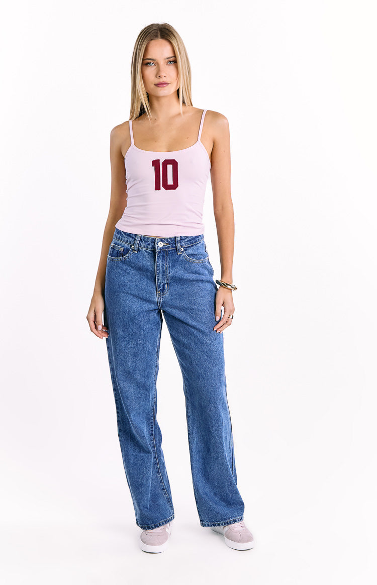 Front view of a light pink jersey cami top with thin spaghetti straps and a dark red '10' graphic