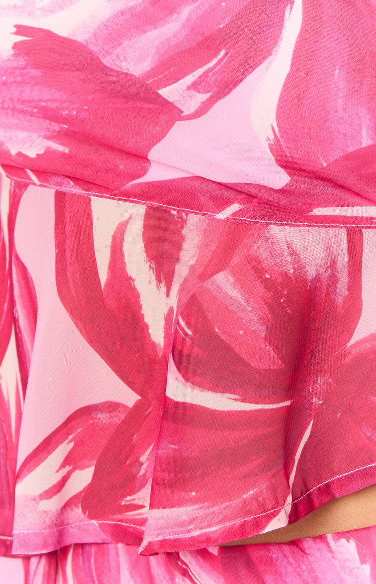 Close-up of the pink floral print fabric showing a layered ruffle detail with white stitching