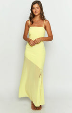Front view of a yellow maxi dress with a square neckline, thin straps, and an asymmetrical chiffon overlay skirt with a high slit