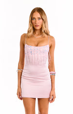 Front view of a light pink bodycon mini dress with a sequined bust and delicate beaded fringe detail