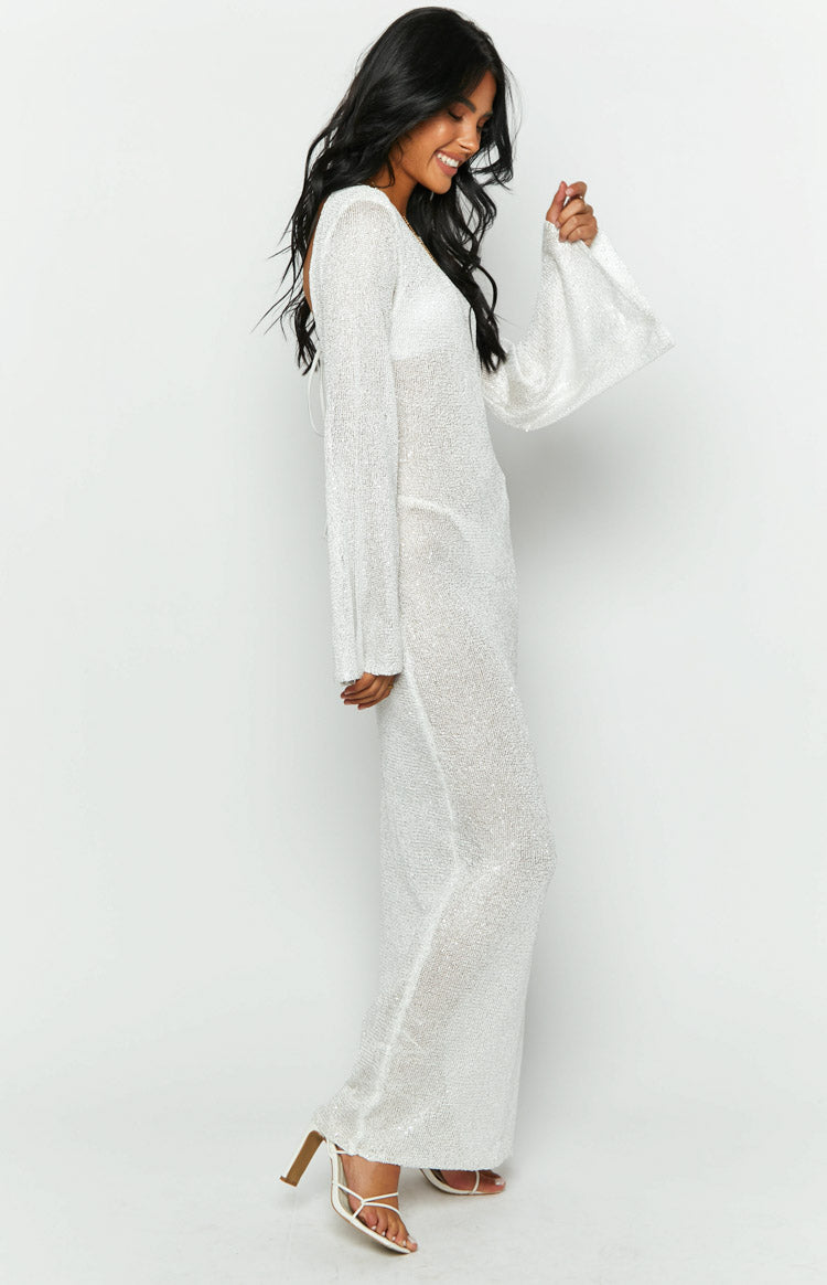 Side view of a white sequin knit maxi dress with long bell sleeves and an open back tie detail