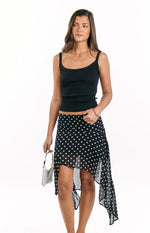 Black polka dot midi skirt with a flowing hanky hem and sheer fabric