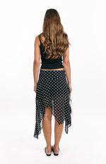Rear view of the black polka dot midi skirt with a sheer hanky hem