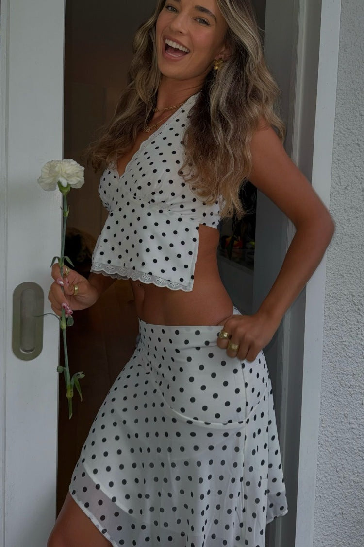 Side view of a white polka dot hanky hem midi skirt with a flowy silhouette