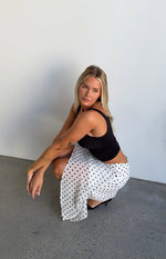 Beginning Boutique Khalea White Polka Dot Hanky Hem Midi Skirt white sheer polka dot midi skirt with a flowy hanky hem