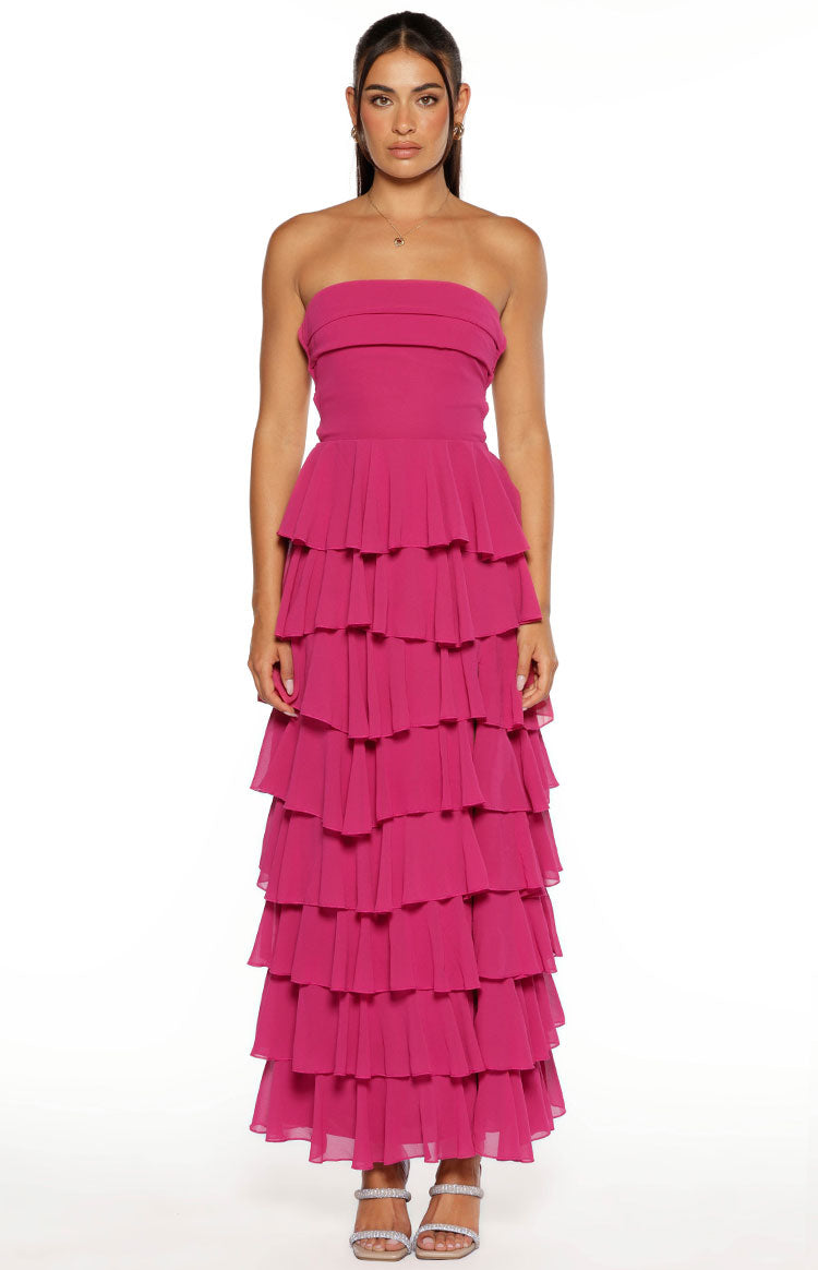 Fuchsia strapless maxi dress with a fitted bodice and a full skirt made of cascading tiered ruffles